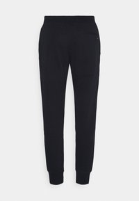 Svarta bomullsjoggers med en avsmalnande bendesign, elastisk midja och muddade anklar, med en bakficka för förvaring.