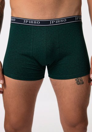 Boxers à motif vert en tissu doux, avec une ceinture navy portant la marque "JP1880" et un design ajusté.