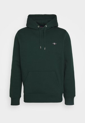 Dunkelgrüner Hoodie aus Baumwolle, ausgestattet mit einer Vordertasche, verstellbarem Kordelzug an der Kapuze und einem kleinen Logo auf der Brust.