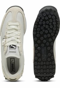 Baskets blanches et beiges en daim et mesh, avec une pointe arrondie, un design à lacets et une semelle en caoutchouc noire texturée.