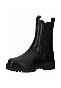 Botas de tobillo de cuero negro con paneles laterales elásticos, suela de goma texturizada y la marca "TOM TAILOR" en el lado. Diseño sólido y duradero.