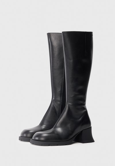 Botas pretas de couro até ao joelho com salto bloco, fecho éclair lateral, textura lisa, biqueira arredondada e sola de borracha robusta.