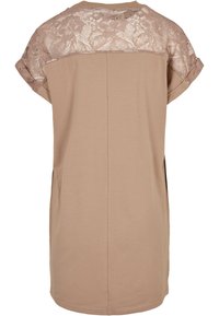 Beež värvi tuunikas pitsilise detailiga õlgadel, ümmarguse kaelusega ja üleskeeratud lühikeste varrukatega. Pehme tekstuur, lõdvestunud lõige ja sirge alläär.