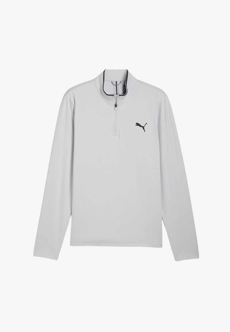 Šviesiai pilkas ilgomis rankovėmis megztinis su užtrauktuku prie kaklo, kairėje krūtinės pusėje juodas logotipas ir lygios siūlės, kad būtų lygi apdaila.