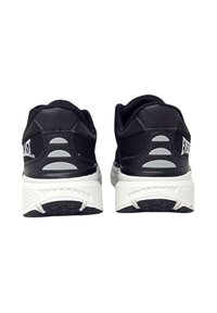 Scarpe da ginnastica nere con una tomaia testurizzata, suola intermedia bianca e suola esterna con motivo. Presentano un logo sul tallone e dettagli riflettenti.