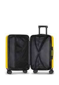 Yellow hard-shell suitcase with a two-compartment interior, black lining, adjustable straps, and a retractable handle. Four rolling wheels.