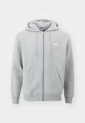 Grå dragkedjetröja tillverkad av mjukt material. Har en framdragkedja, två sidofickor och en huva med snörning. Vit logotyp på bröstet.