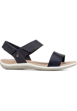 Sandalias de cuero azul marino con tiras entrelazadas y una plantilla ancha. Presentan una suela blanca texturizada con un ligero tacón y detalles decorativos.