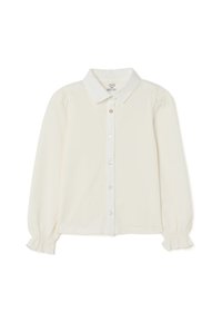 Cream-colored button-up blouse with long sleeves, puffed shoulders, a classic collar, and ruffled cuffs; smooth fabric with a subtle sheen.