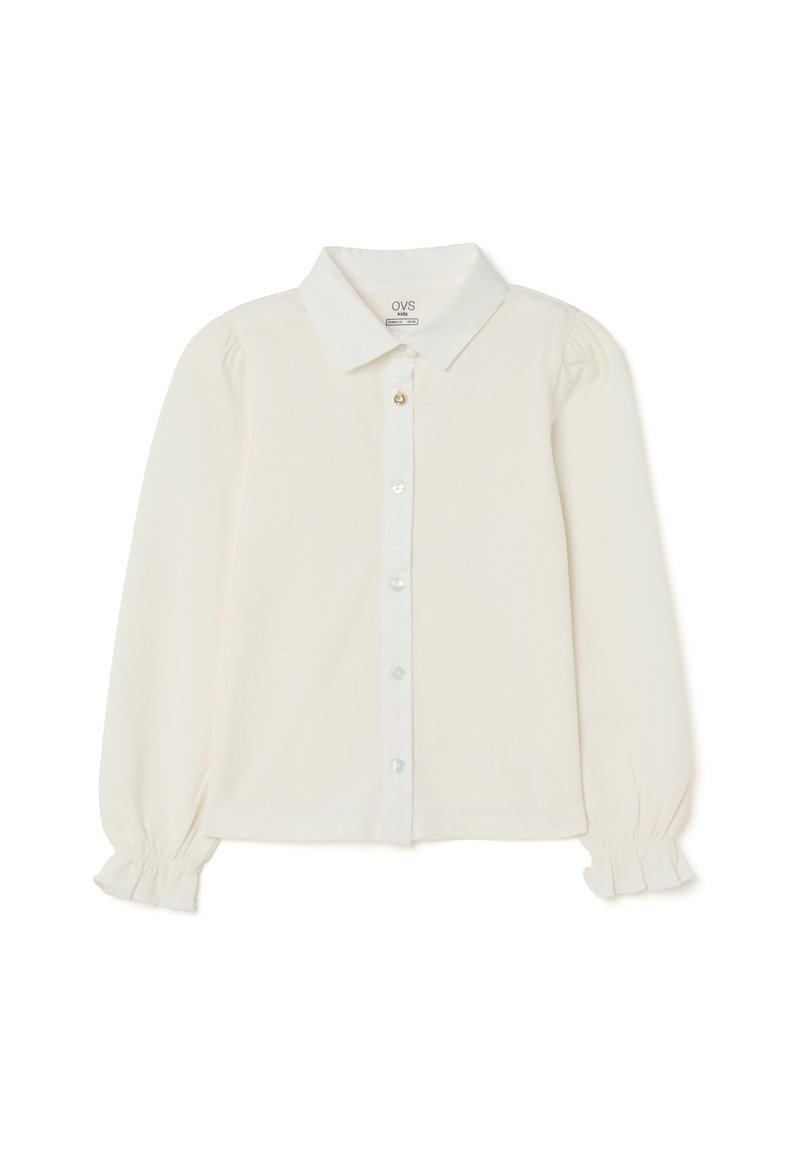 Cream-colored button-up blouse with long sleeves, puffed shoulders, a classic collar, and ruffled cuffs; smooth fabric with a subtle sheen.