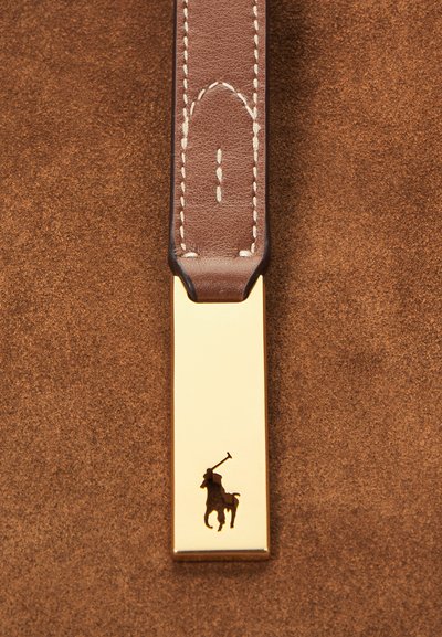 Brunt læderrem med hvid syning fastgjort til en guldfarvet metalplade med silhuet af en polospiller til hest.