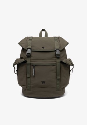 Dark green backpack with flap and buckle closures, front zipper pocket, two side pockets, top handle, and "W" logo on front panel.