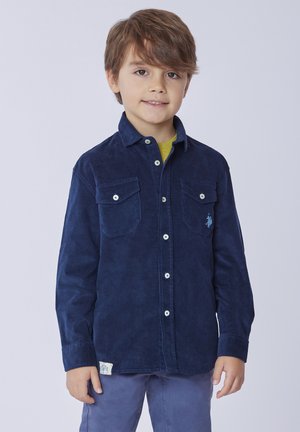 Camicia di velluto a coste blu navy con colletto button-down, due tasche sul petto, bottoni bianchi e un piccolo logo ricamato su una tasca.