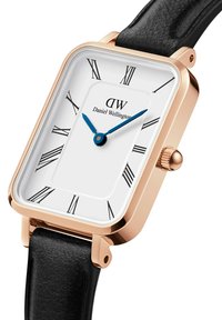Square watch with a white face, Roman numerals, and blue hands. Gold-tone case with a black leather strap. Minimalistic design.