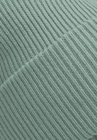 Textured mint green fabric with a ribbed pattern, featuring fine strands woven in diagonal lines. Smooth surface with a soft appearance.