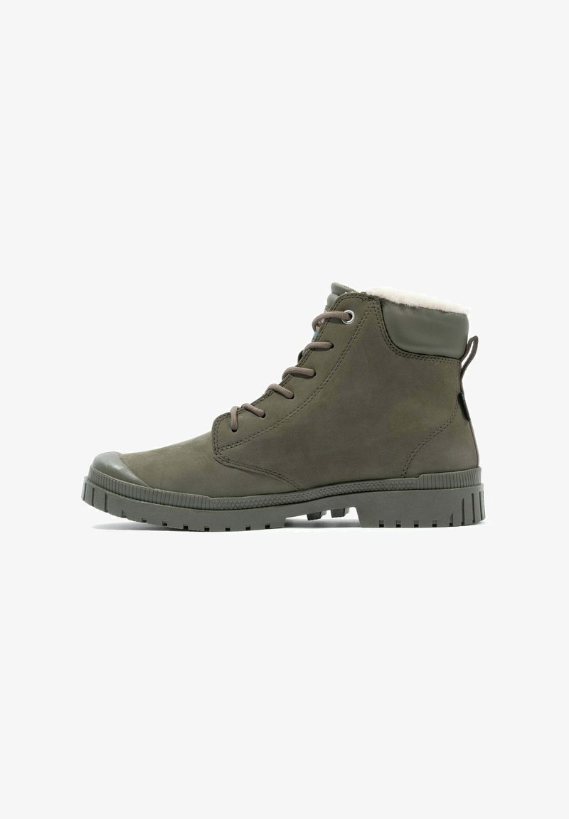 Olive green ankle boots with a suede finish, featuring a soft fur lining, round toe, and textured rubber sole with deep grooves.