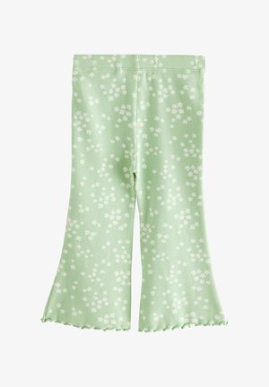 Svetlo zelene hlače s flared krojem iz rebraste tkanine, ki vključujejo bel cvetlični vzorec in robove s valovitim zaključkom.