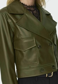 Giacca in pelle verde oliva con abbottonatura doppiopetto, ampie reverse e due tasche frontali. Presenta una texture liscia e una vestibilità strutturata.