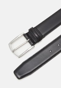 Ceinture en cuir noir avec une boucle rectangulaire en argent, dotée de coutures contrastantes et de plusieurs trous d'ajustement le long de la sangle.