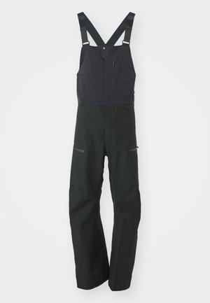 Salopettes isolées noires avec des bretelles réglables, une poche zippée sur la poitrine et deux poches avant. Tissu lisse et durable avec une finition mate.