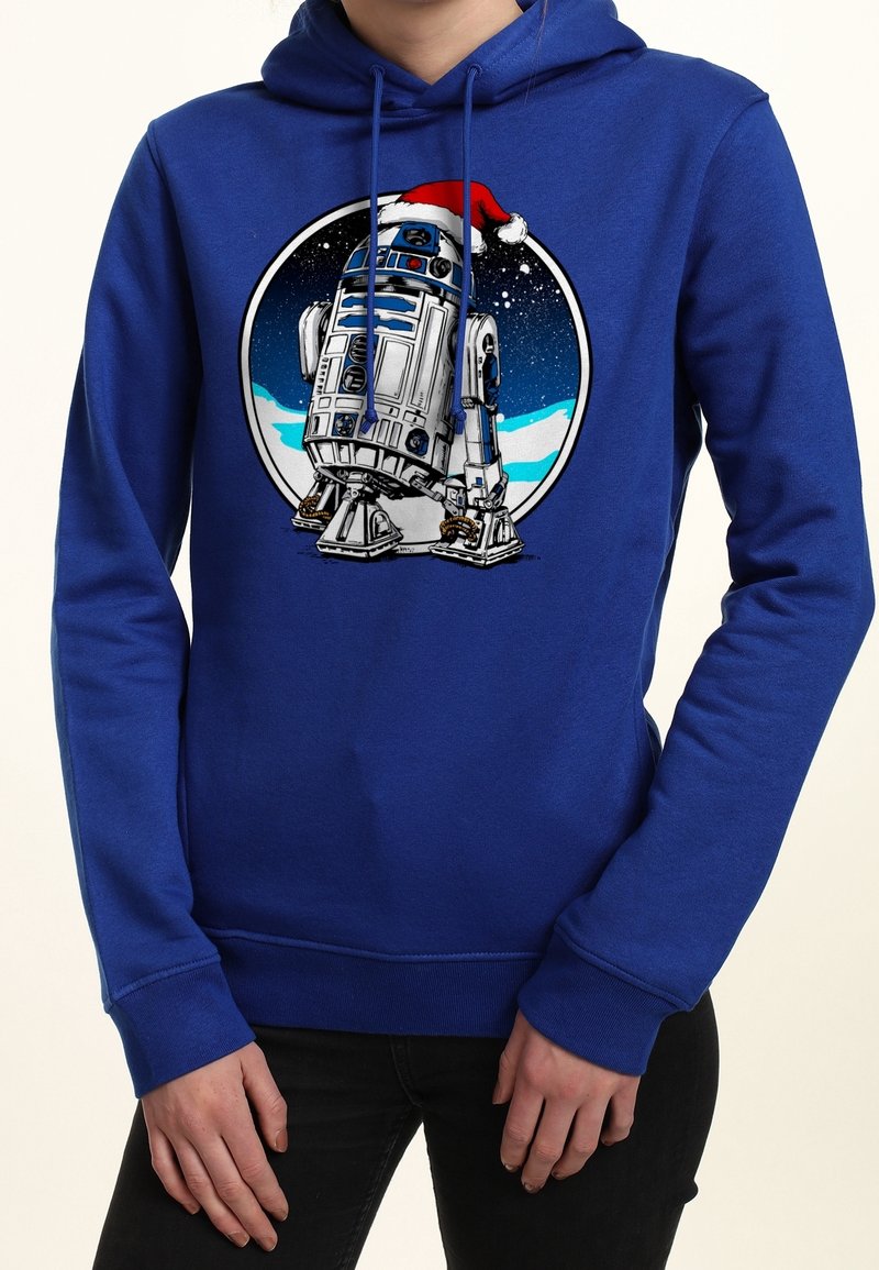 Sweat à capuche bleu avec R2-D2 sur le thème des fêtes portant un chapeau de Père Noël, sur fond de nuit étoilée et enneigée à l'avant.