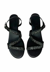 Sandali neri con cinturini scintillanti in glitter, fibbia regolabile alla caviglia e suola piatta. Texture liscia e design aperto adatti per il clima caldo.