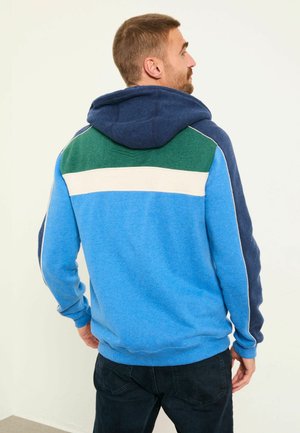 Hooded sweatshirt featuring blue, green, and cream color blocks; made of soft fabric with a relaxed fit and ribbed cuffs and hem.