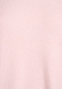 Light pink knitted fabric with a ribbed texture, featuring even stitches and a soft appearance. Suitable for warm clothing.