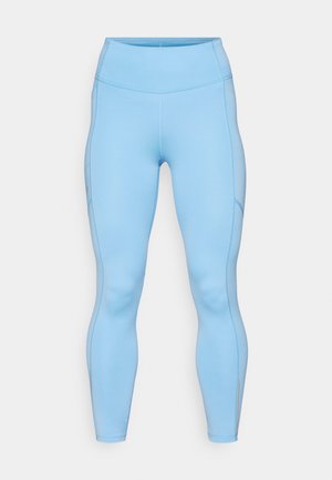 Svetlomodré legíny vyrobené z elastického materiálu. Obsahujú vysoký pás, hladký povrch a zakrivené švy pozdĺž nôh.