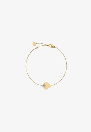 Kuldset ketist käekett südamekujuga ripatsiga ja väikese läbipaistva vääriskiviga, mida kinnitatakse homaari-klambriga ning mille kett on reguleeritava pikkusega.