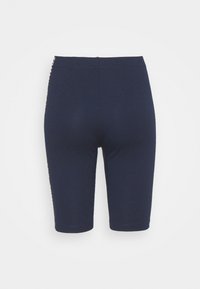 Mörkblå cykelbyxor i en elastisk bomullsblandning, med en slät yta och en åtsittande design som ger komfort och rörelsefrihet.