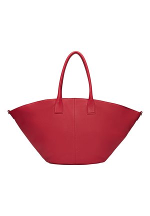 Red leather tote bag with a wide, curved shape and short handles. Features a smooth texture and minimalistic design, no visible hardware.
