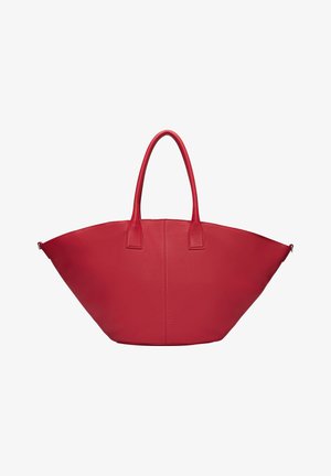 Red leather tote bag with a wide, curved shape and short handles. Features a smooth texture and minimalistic design, no visible hardware.