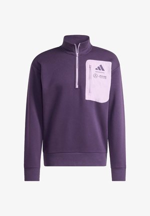 Fioletowa bluza z półzamkiem, z białą kieszenią na zamek i logo marki na piersi oraz rękawie.