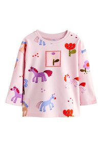 Chemise rose à manches longues pour enfant avec des illustrations colorées de licornes et de fleurs dispersées sur le tissu.