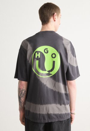 Gray tie-dye t-shirt with a large green circular graphic featuring the letters "HGO" and a smiley face design on the back.