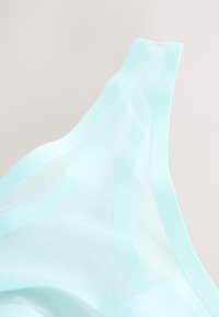 Light blue sheer fabric with a smooth texture and subtle transparency, featuring a broad, flat band along the edge.