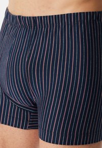 Námořnické boxerky s vertikálními růžovými a bílými pruhy, s měkkým elastickým pasem a hladkým bavlněným materiálem.