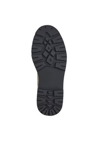 Semelle en caoutchouc noir avec des profondeurs et un motif en diamant pour une meilleure traction. Bords renforcés pour la durabilité et le soutien dans les terrains accidentés.