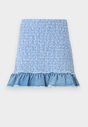 Light blue tweed skirt with a ruffled denim hem, featuring a textured pattern and frayed edges, creating a layered look.