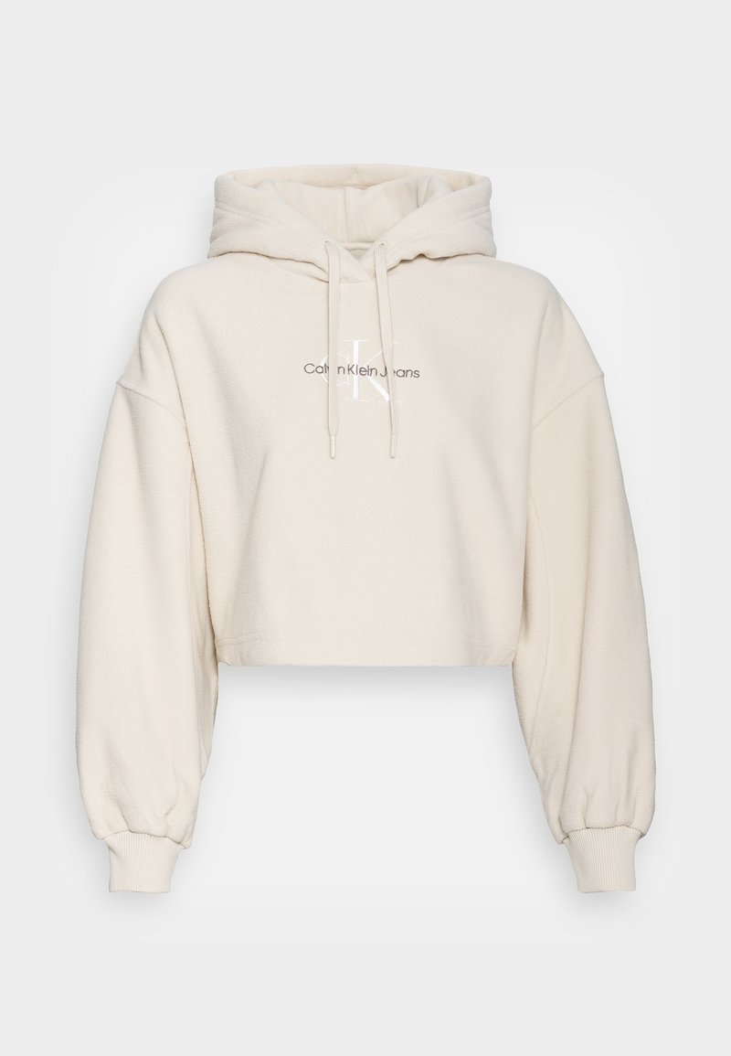 Felpa con cappuccio corta color crema in tessuto morbido e testurizzato. Presenta un cappuccio con coulisse e polsini a costine, con un logo stampato sul davanti.