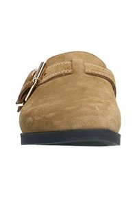 Tan suede slip-on shoe with a rounded toe, featuring a contrasting strap and metal buckle detail, set on a black rubber sole.