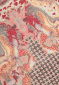 Textile with swirling red, pink, and gray patterns alongside a houndstooth design in black and white. Soft, smooth texture.