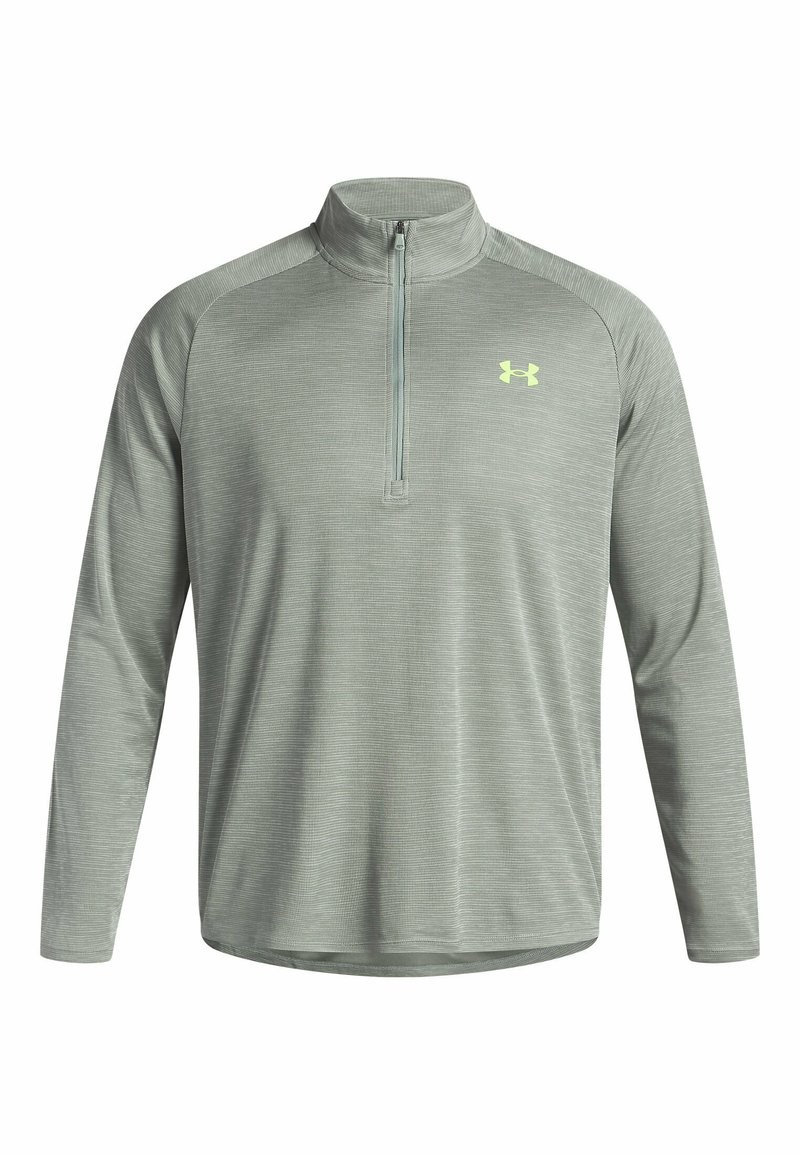 Pull-over de sport vert clair avec un col zippé mi-hauteur, manches longues, tissu texturé et un petit logo jaune sur la poitrine.