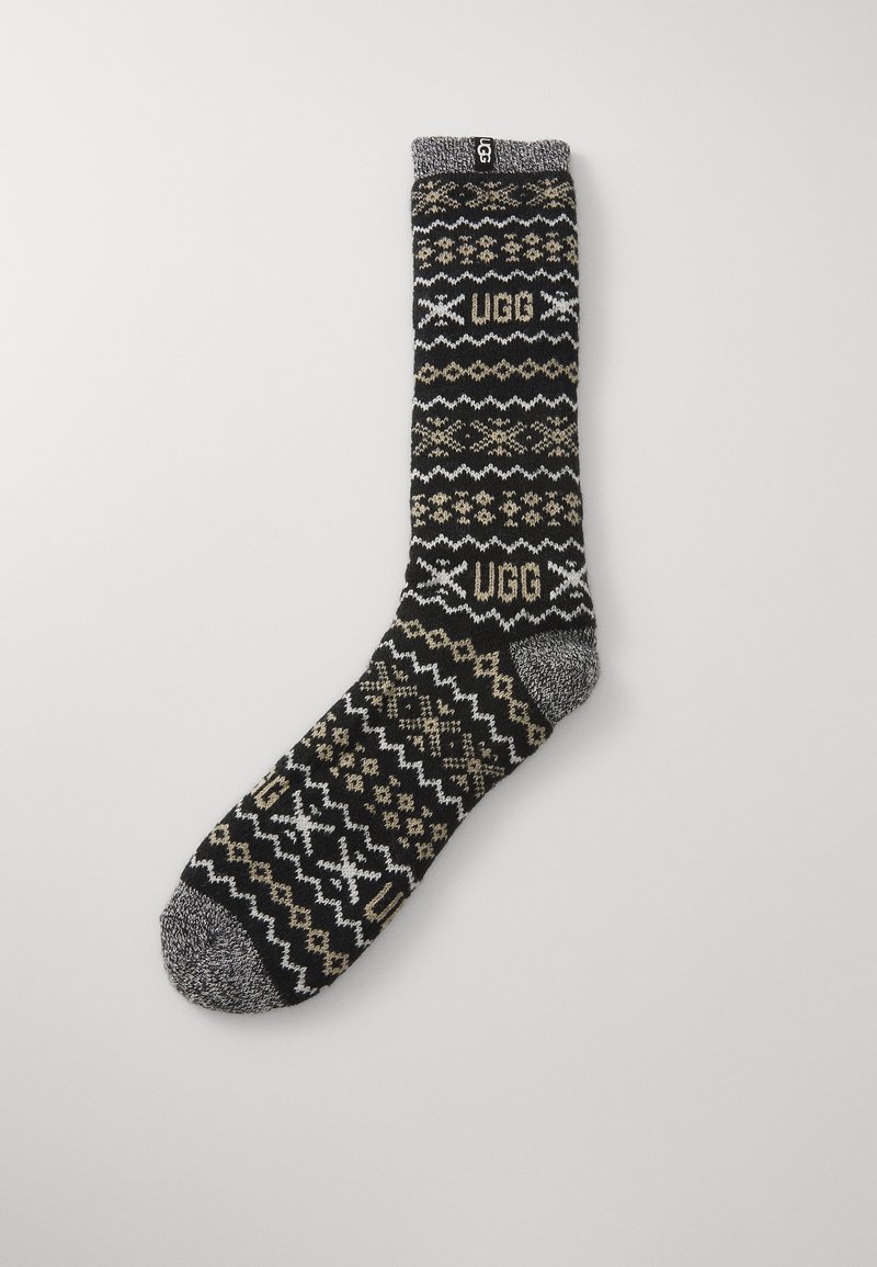 Black and beige patterned sock featuring a geometric knit design, UGG branding, and a gray toe. Soft fabric with a cozy texture.