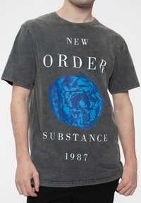 Gray cotton t-shirt featuring a blue rose graphic, "NEW ORDER," "SUBSTANCE," and "1987" text in white, with a round neck and short sleeves.