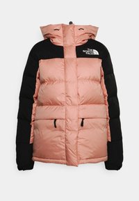 Puffer jacket with a black top and soft pink lower section, featuring a hood, two front pockets, and The North Face logo on the chest.