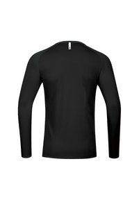 Chemise noire à manches longues avec un col rond, texture lisse et manches raglan contrastantes. Présente une petite étiquette au niveau de l'encolure arrière.
