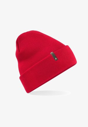 Red knitted beanie hat with a ribbed texture, featuring a folded cuff and a small branded tag on the side.