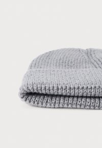 Gray knitted beanie hat, featuring a ribbed texture, folded cuff, soft material, and a snug fit. No visible patterns or embellishments.